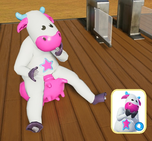 Cosmic Cow, een witte koe met fuchsia snuit en dito uier, stuitert op haar uier voor de Parkingang. Rechtsonderaan staat het portretje zoals het verschijnt in het spelmenu.