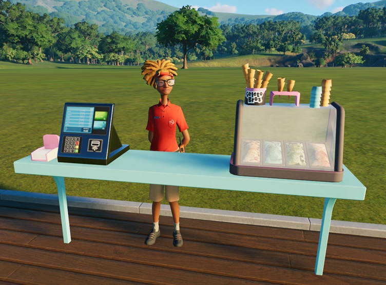 Een lichtblauwe Gelato Bros-toonbank, met links de betaalterminal en een doosje met servetten. Rechts staat de koeltoonbank met vier bakken Gelato-ijs; bovenop de koeltoonbank staan lege ijshoorntjes en lege potjes. De Verkoopster heeft lang blond haar in een paardenstaart; ze draagt een grote bril.