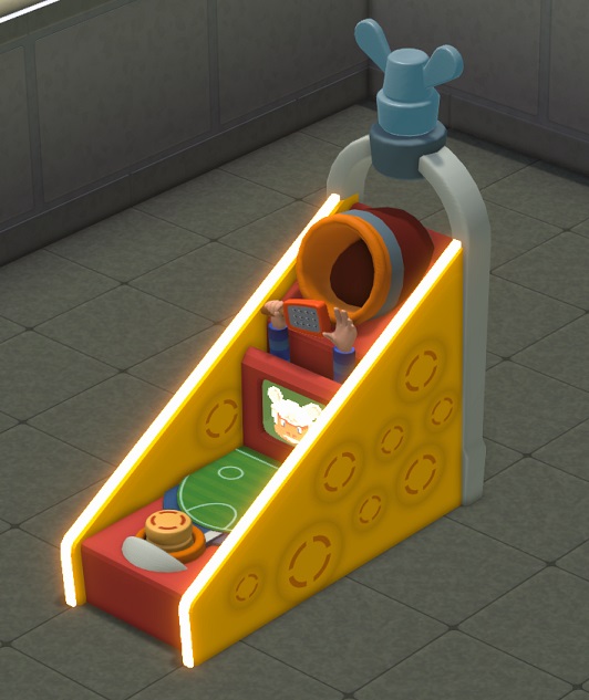 De Cheeseball Arcade is een driehoekige automaat met vooraan een gele drukknop en achteraan een verkleinde versie van een Cheeseball-doel. Voor het doel staan twee (bewegende) handen; één hand houdt een kaasrasp vast.