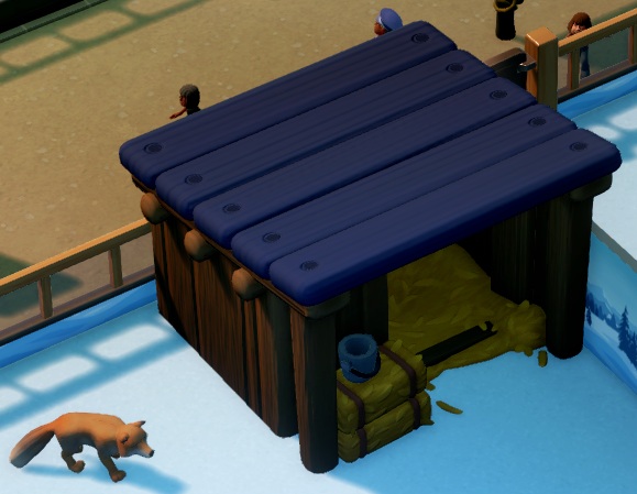 De Baby Hutch is een 'mini-stal', een houten afdakje met paars dak, gevuld met stro.
