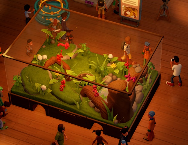 In een Large Terrarium zitten zes Balloon Animals, met roze/rode vacht in een Grasland-omgeving. Bezoekers lopen rond het Terrarium.