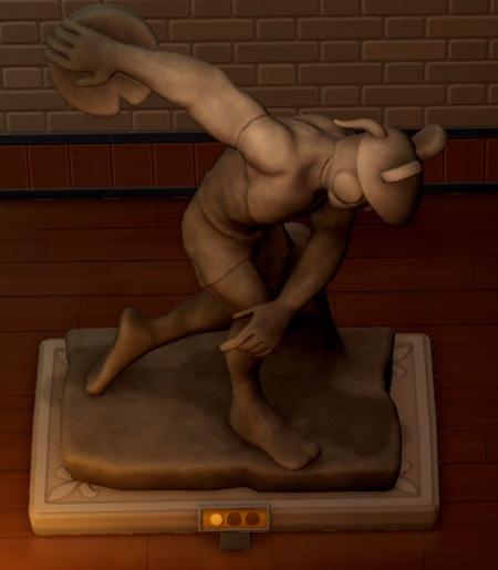 Een standbeeld van een Cheeseball-atleet die op het punt staat, een schijf kaas weg te werpen.