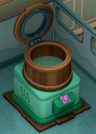 De Micro Animal Spa bestaat uit een ronde, houten 'badkuip', met bovenaan een rond afsluitdeksel. De 'badkuip' staat op een groene doos, met een lichtpaarse drukknop erop.