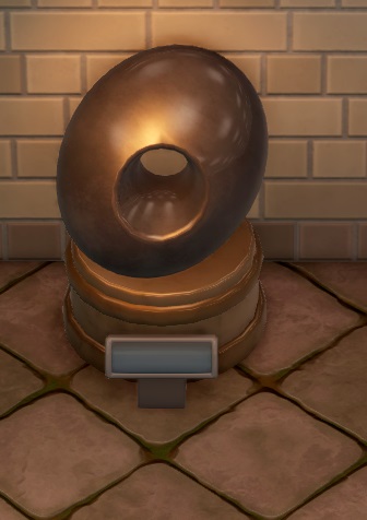 Een groot metalen standbeeld van een olijf, met in het midden een ronde opening van de voor- tot aan de achterkant.