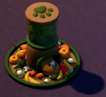 De Plant Food Dispenser is een rond Object, gevuld met fruit en groenten. In het midden staat een verticale cilinder, gevuld met plantaardig voedsel, met een opening onderaan. De Plant Food Dispenser is groen beschilderd.
