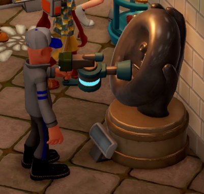 De 'Removal Crew' haalt een Impressionist Statue op, door er met een soort 'pistool' op te stralen. De werker draagt een grijs werkpak.