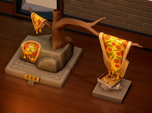 Een standbeeld van een boomstam , met een lange tak. Op het uiteinde van die tak hangt een pizza, die langzaam 'smelt'. Op een kleinere tak hangt nog een 'smeltende' pizza, en vóór de boomstam , op een rots, ligt een derde pizza. Onderaan het uiteinde van de langste tak staan drie opeengestapelde pizzadozen; de bovenste doos is open.